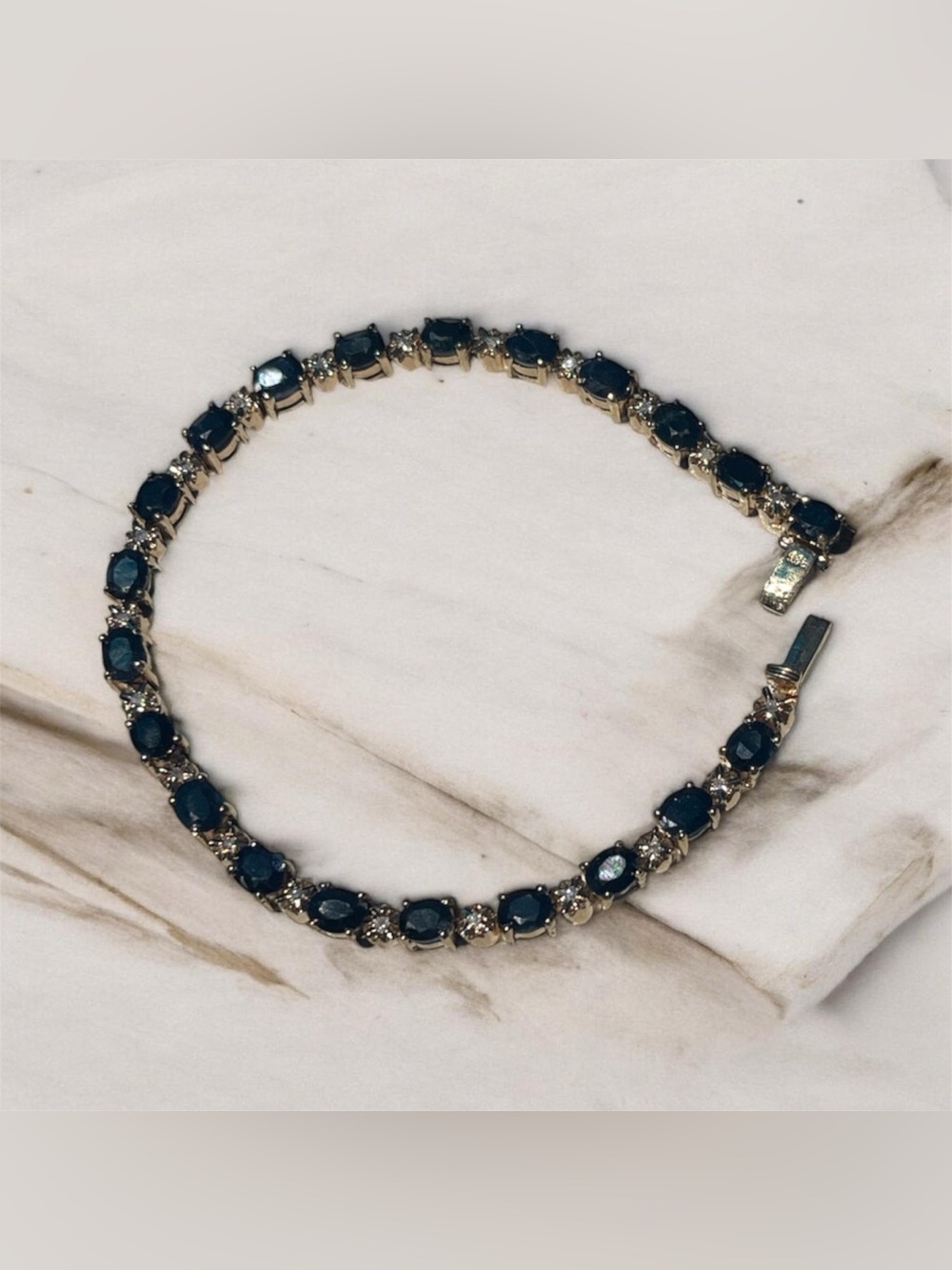 Sterling Silver gold Tennis Bracelet with Sapphire and accent stones.